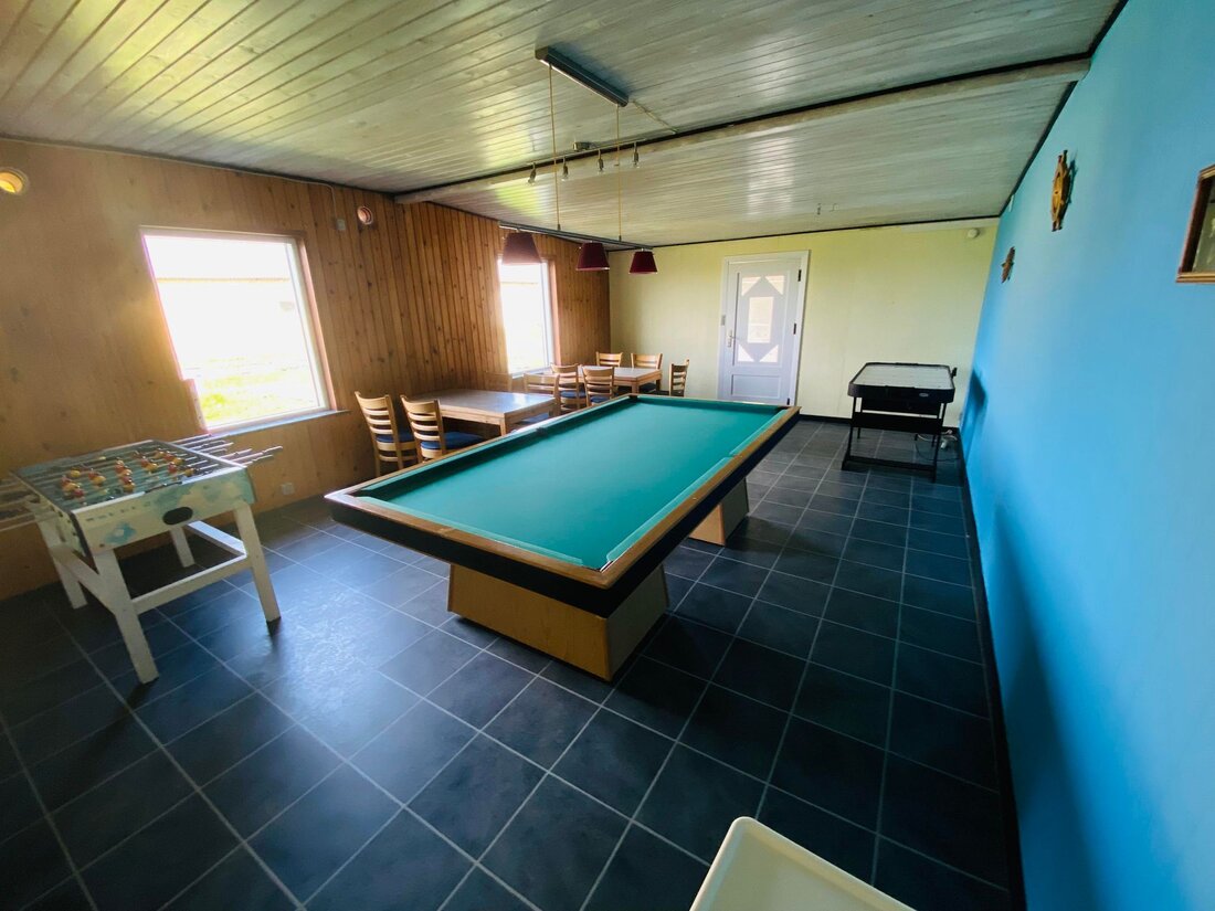 Guests playing billiards and air hockey