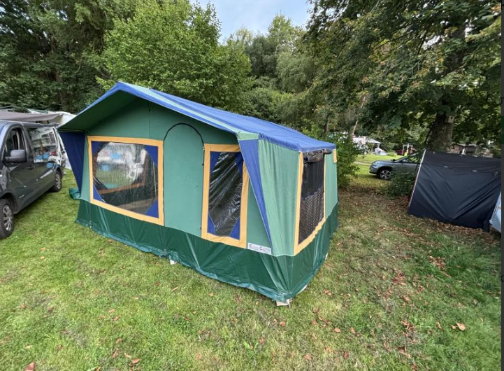 Canvas tent wagon set up on a campsite pitch