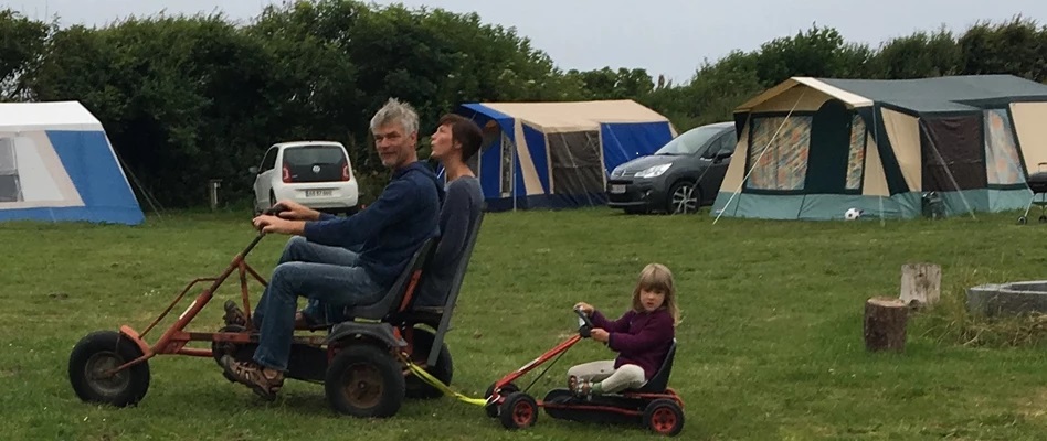Kids riding mooncars at a campsite